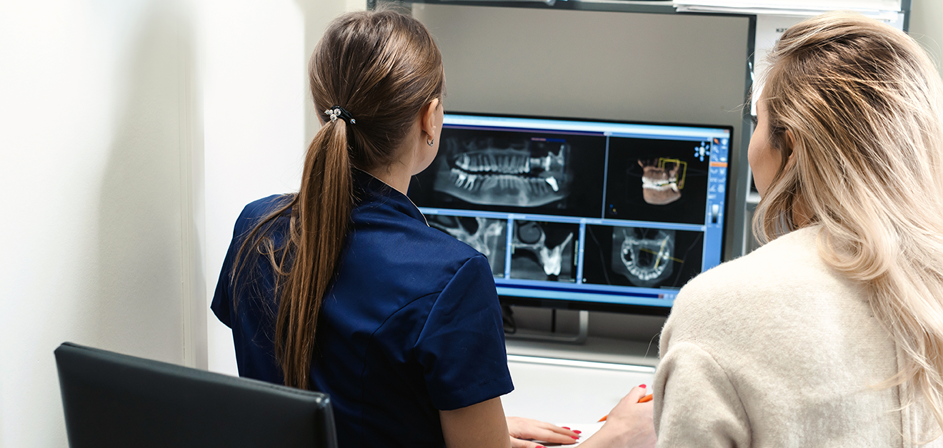 orthodontist assessing teeth xrays in braces consultation