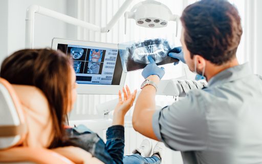 Dentist clinic consultation with dentist explaining x-ray to patient