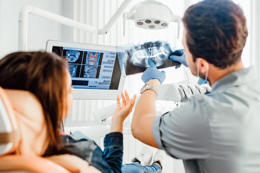 Dentist clinic consultation with dentist explaining x-ray to patient