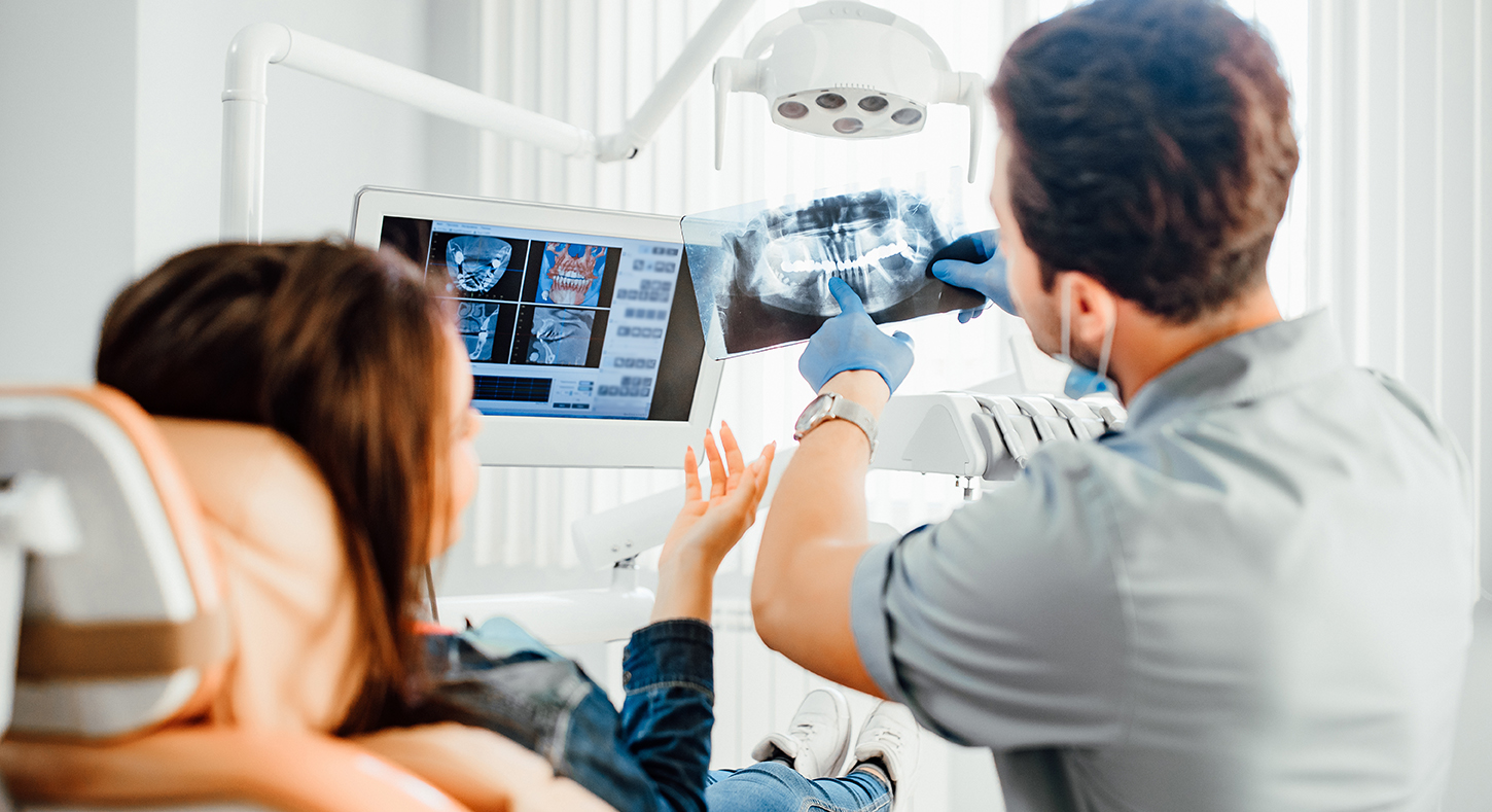 Dentist clinic consultation with dentist explaining x-ray to patient